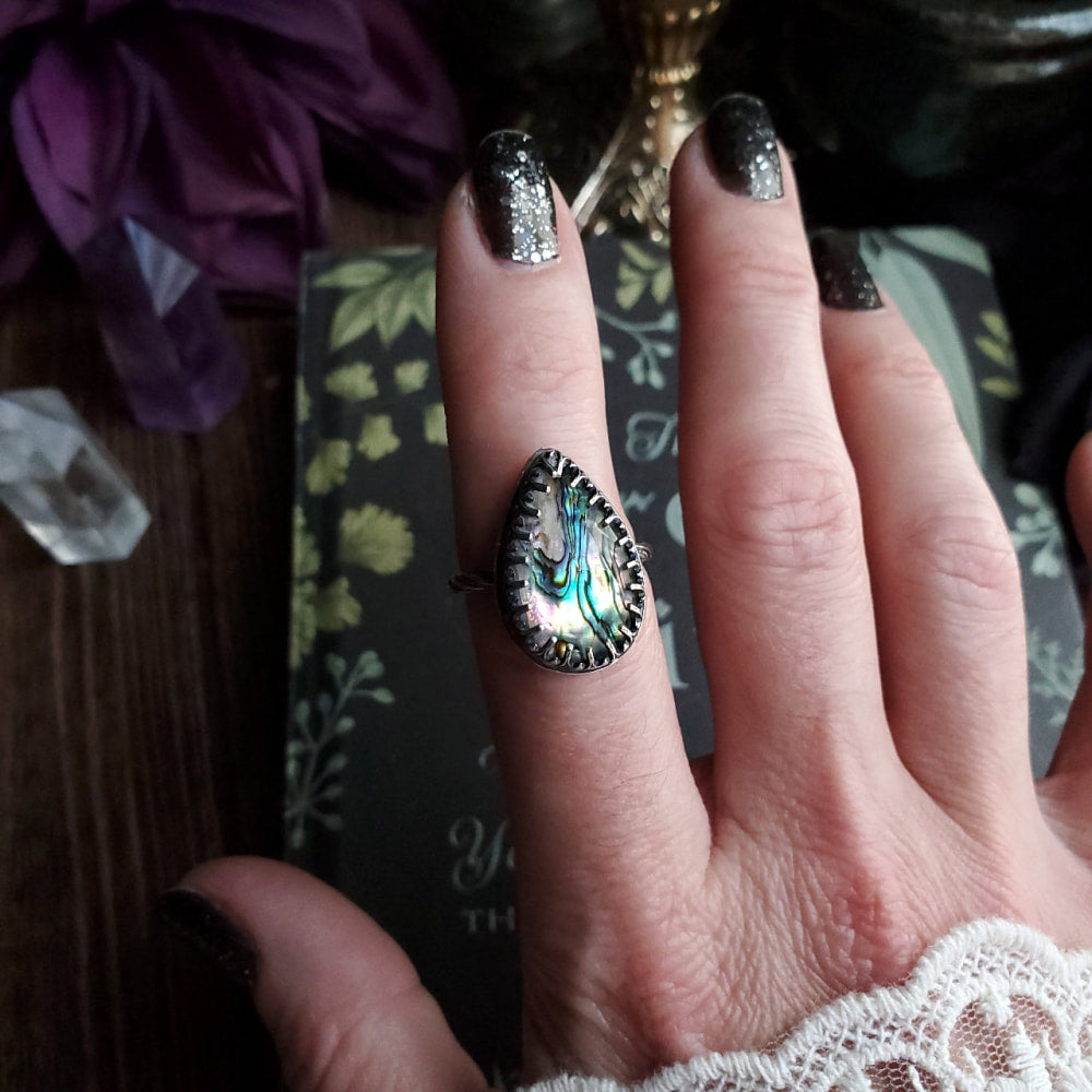 a woman’s hand with a ring on it