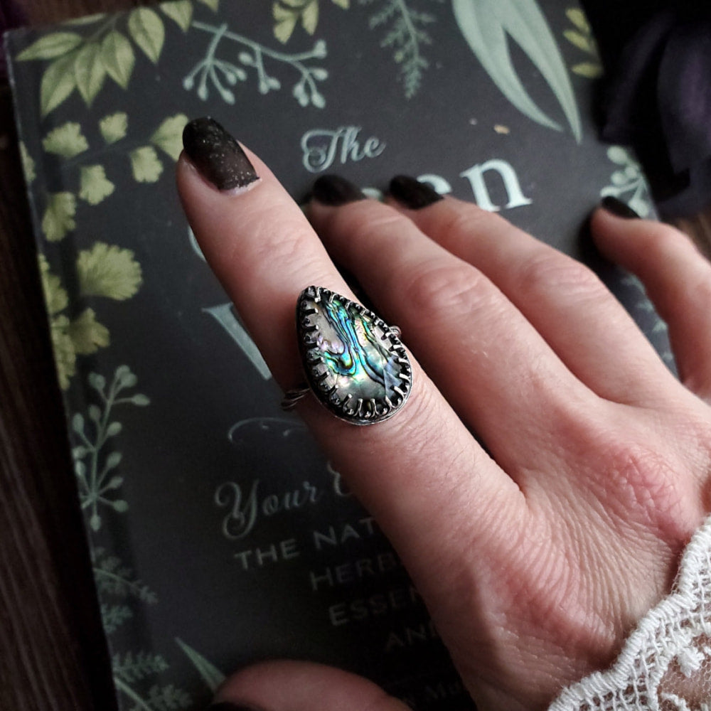 a woman’s hand with a ring on it