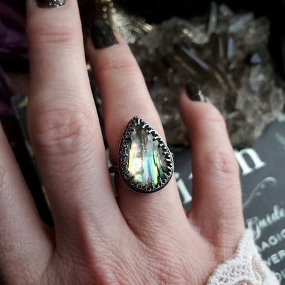 a woman’s hand with a ring on it