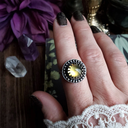 a woman’s hand with a ring on it