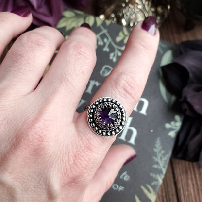 a woman’s hand with a ring on it