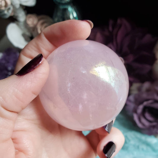 a person holding a pink ball in their hand