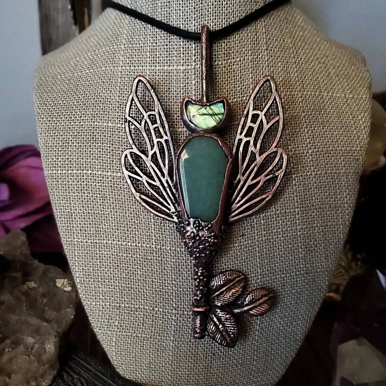 Copper electroformed necklace with a green aventurine cabochon and labradorite accent, featuring intricate fairy wing and leaf details.