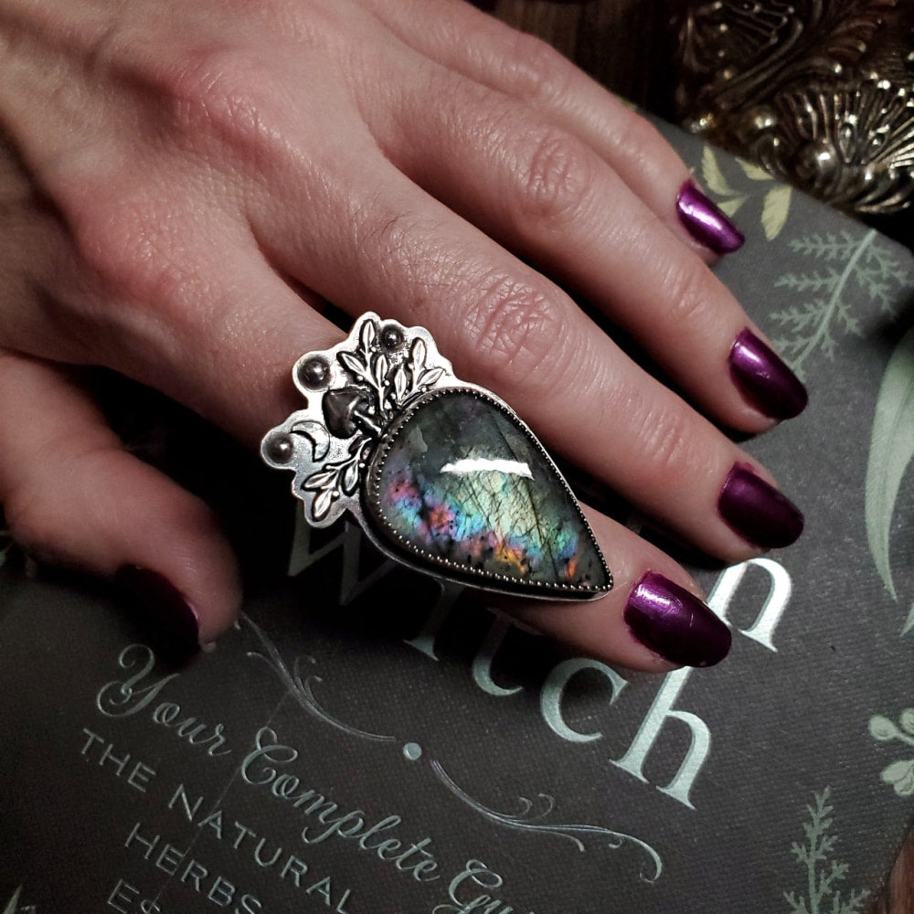 a woman’s hand with a ring on it