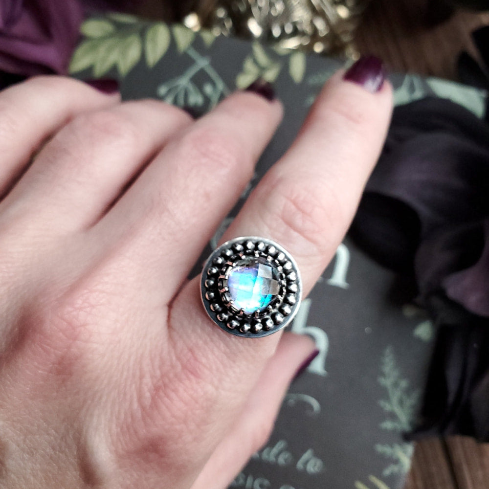 a woman’s hand with a ring on it