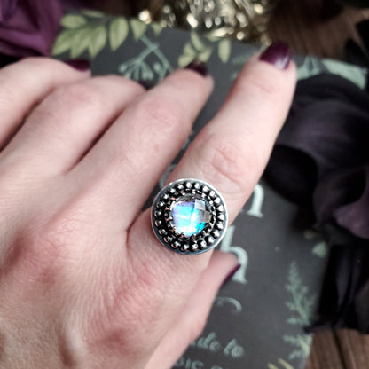 a woman’s hand with a ring on it