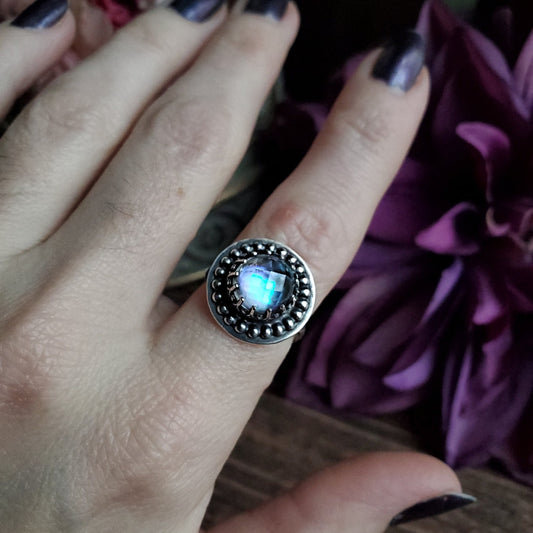 a woman’s hand with a ring on it