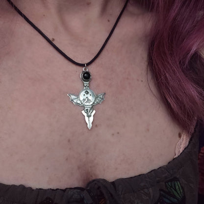 Silver bat-winged pendant necklace.