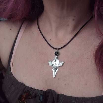 Silver bat-winged pendant necklace.