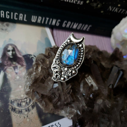a ring with a blue stone in it