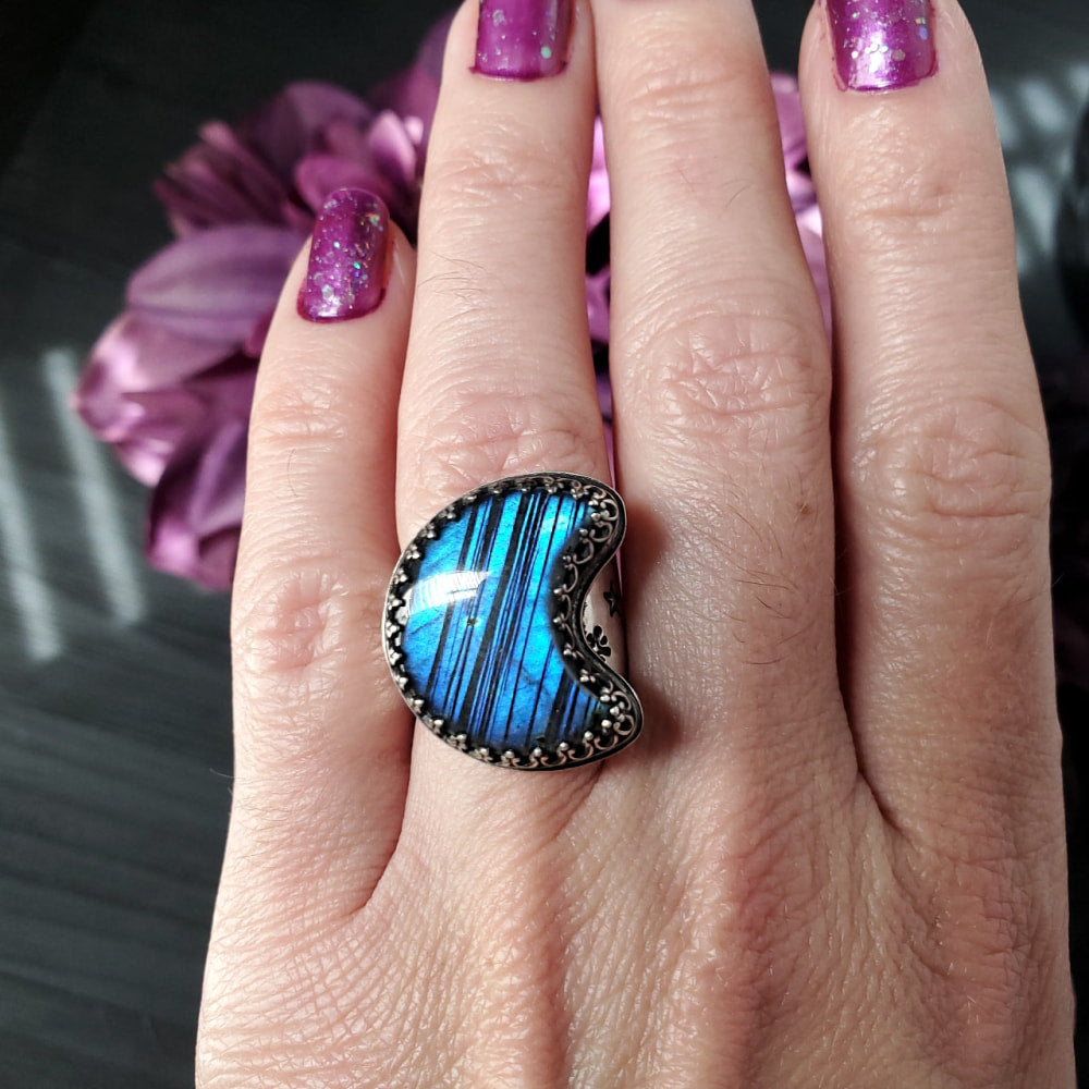 a woman’s hand with a blue ring on it