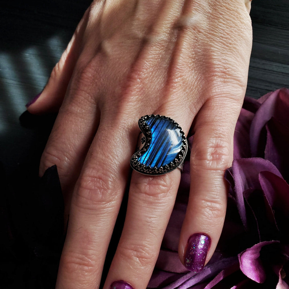 a woman’s hand with a ring on it