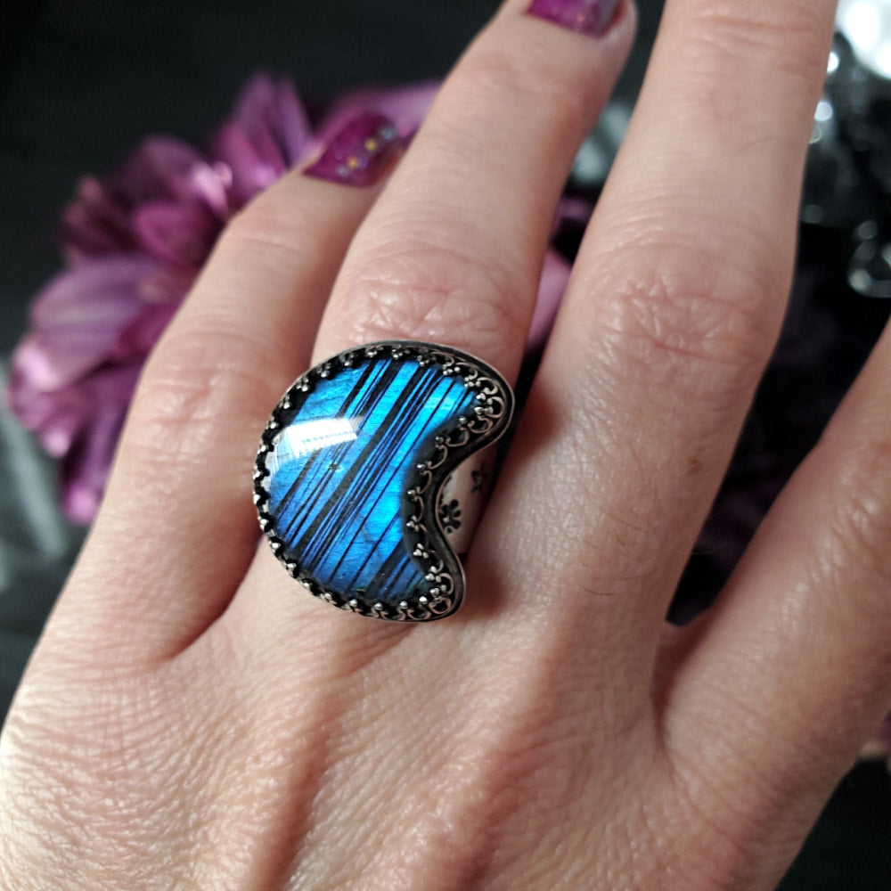 a woman’s hand with a blue ring on it