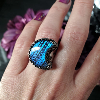 a woman’s hand with a blue ring on it