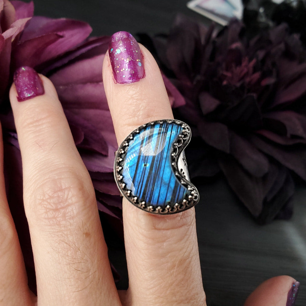 a woman’s hand with a blue ring on it