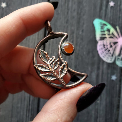 a person holding a ring with a butterfly on it