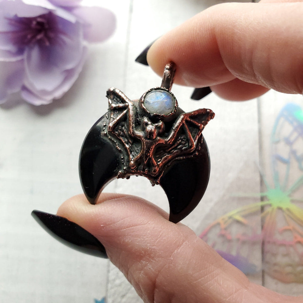 a person holding a ring with a dragon on it