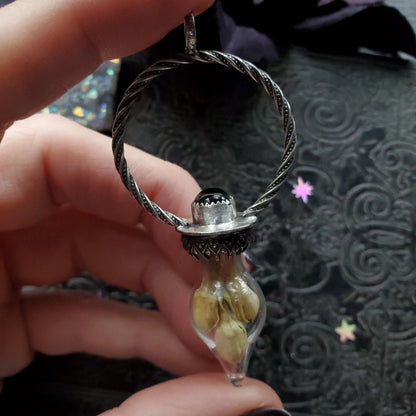 a person holding a ring with a stone inside