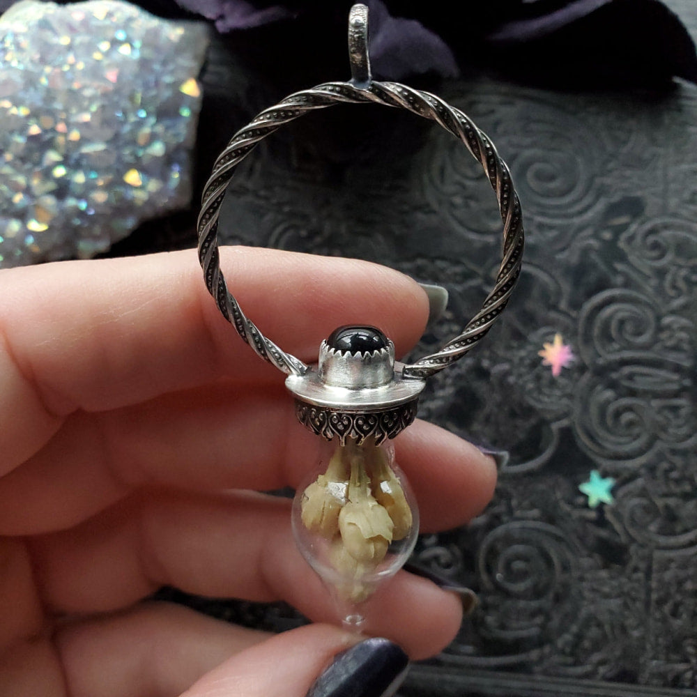 a person holding a ring with a stone inside