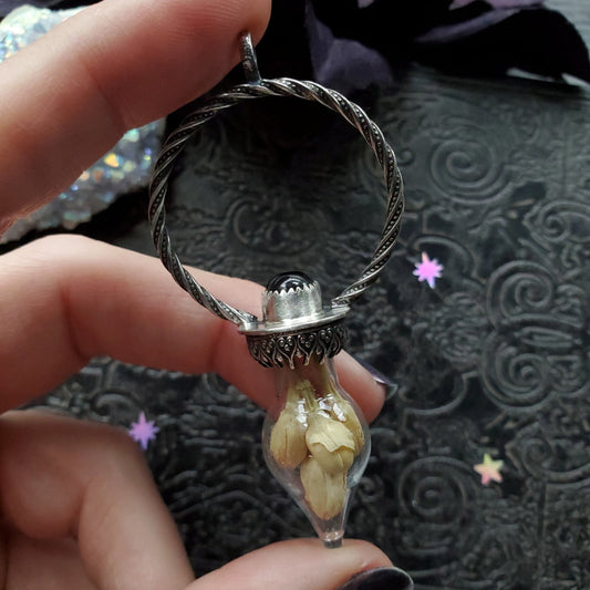 a person holding a ring with a stone inside