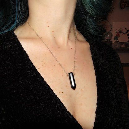 a woman with green hair and a black shirt
