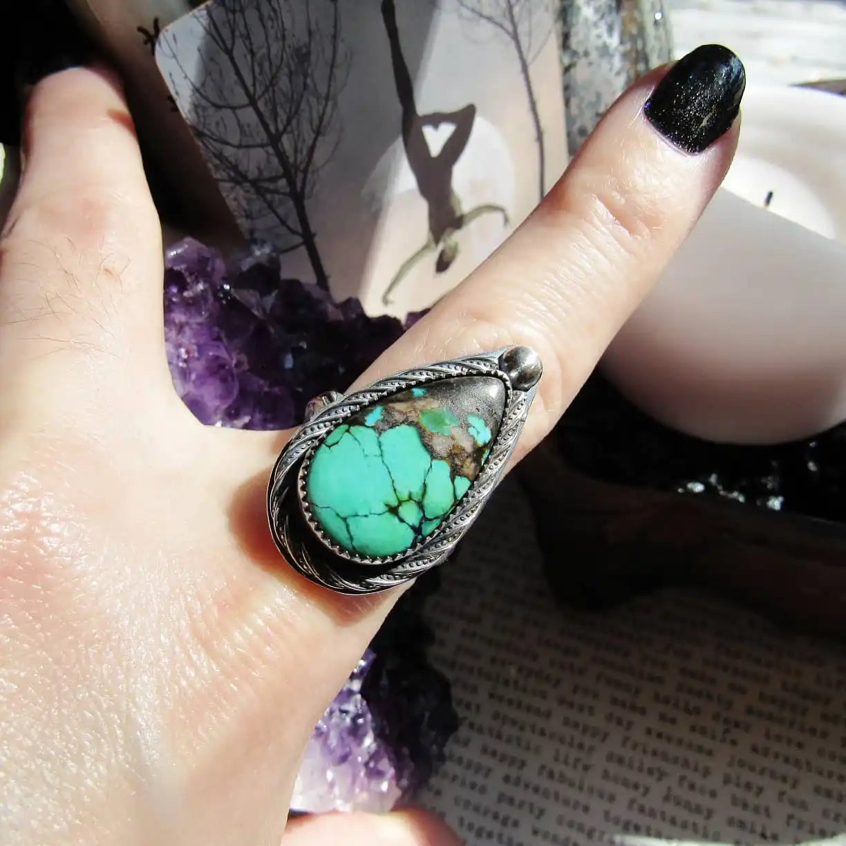 Sterling silver ring with a teardrop-shaped turquoise stone.