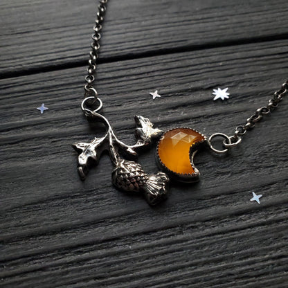 a necklace with a crescent and a star
