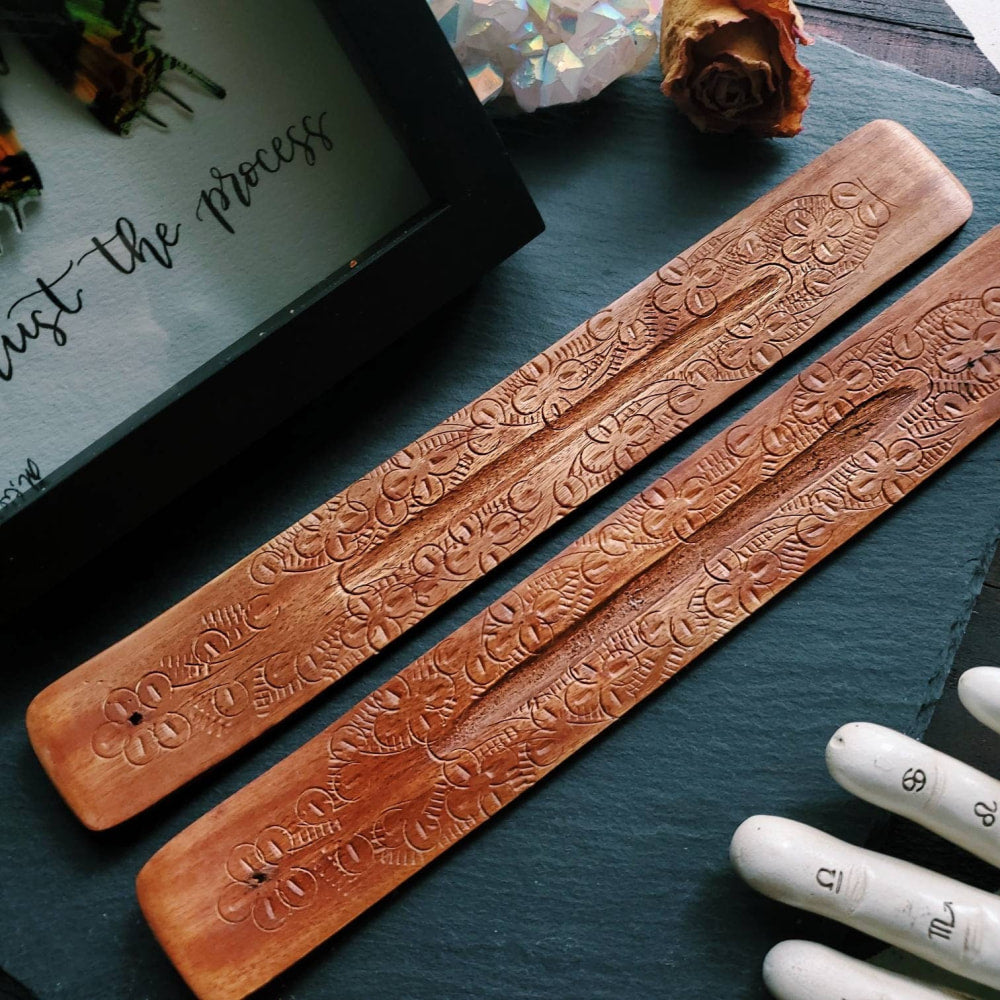 a pair of wooden chops with engraved designs