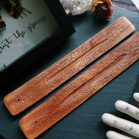 a pair of wooden chops with engraved designs